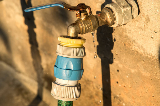 Garden water tap with hose connected with a Hozelock connector - Foto, Imagem