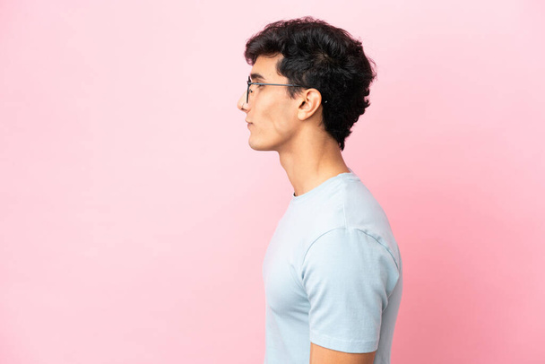 Young Argentinian man isolated on pink background With glasses - Photo, Image