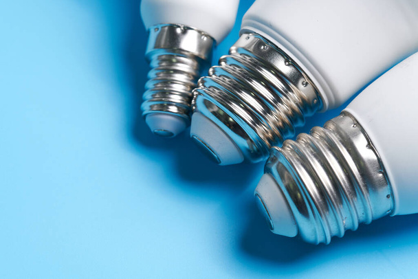 Different types of Light Bulbs isolated on blue background - Foto, Imagen