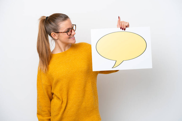 Young caucasian woman isolated on white background holding a placard with speech bubble icon - Photo, Image