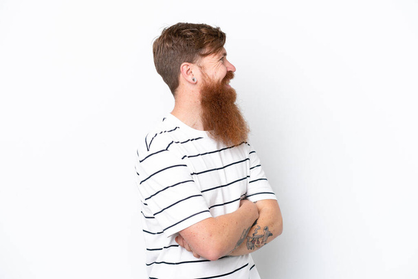 Redhead man with beard isolated on white background looking to the side and smiling - Фото, изображение
