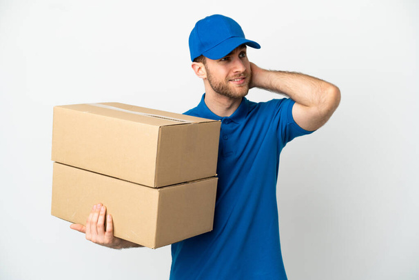Delivery man over isolated white background having doubts - Photo, Image