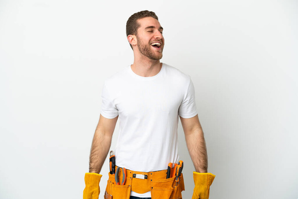 Young electrician man over isolated white wall laughing - Fotoğraf, Görsel