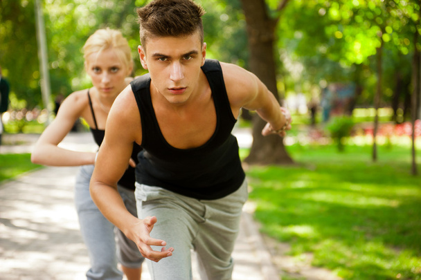 Closeup Portrait of Young Couple Jogging In Park - Fotografie, Obrázek
