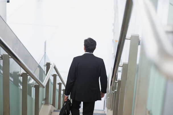 Indian businessman descending steps - Photo, Image