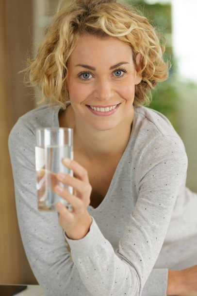 young woman holding glass of water - Foto, immagini