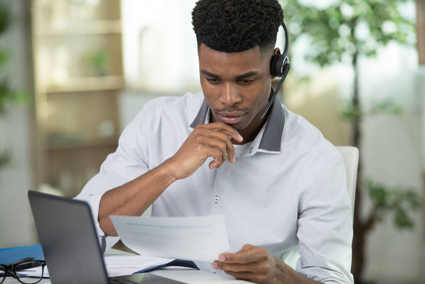 young male businessman employee reading some docs - Photo, Image