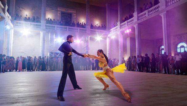 Couple dancers  perform latin dance on large professional stage. - Photo, Image