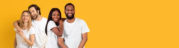 Relationship, love, marriage, family concept. Happy young caucasian and black couples posing on yellow studio background, cheerfully smiling and embracing, panorama with copy space, collage - Photo, Image