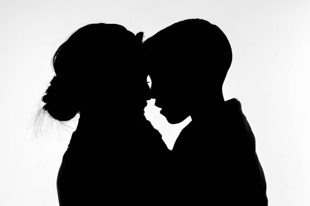 Silhouette of mother with son in her arms on a white background - Foto, Imagem