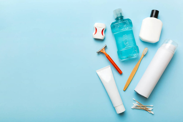Composition with bath cosmetics on table. razor, toothpaste, soap, gel, toothbrush, mouthwash and other various accessories. Cosmetics for skin health. Bath Mockup for your logo. - Photo, Image