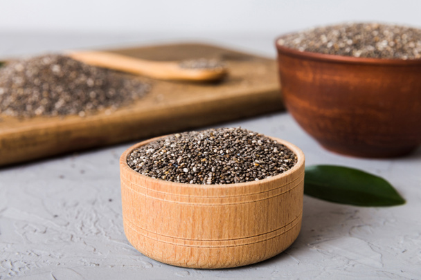 Chia seeds in bowl and spoon on colored background. Healthy Salvia hispanica in small bowl. Healthy superfood. - 写真・画像