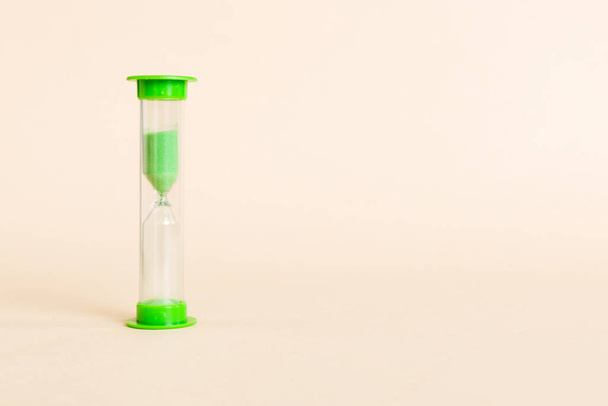 hourglass on the table, sand clock as time passing concept for business deadline, copy space. - Foto, afbeelding