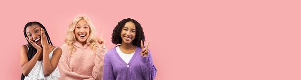 Cute multiethnic young ladies posing on pink studio background, gesturing and smiling at camera, pretty african american and blonde women showing various gestures, panorama with copy space - Photo, Image