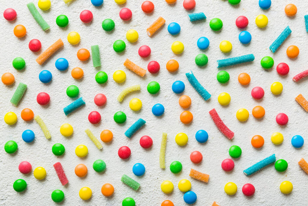 colorful candies as background top view. Seamless pattern with candy. Many sweet candies close-up. - 写真・画像