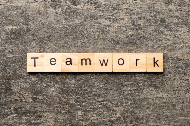 TEAMWORK word written on wood block. TEAMWORK text on cement table for your desing, concept. - Photo, Image