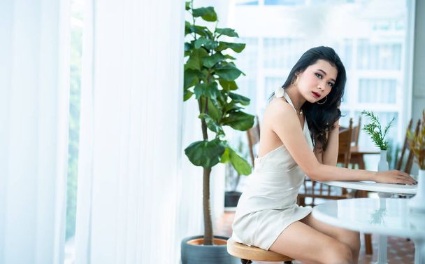 Portrait beautiful asian freelance Success people business woman fashion model in summer white sleeveless dress and coffee in cup in coffee shop. - Photo, Image