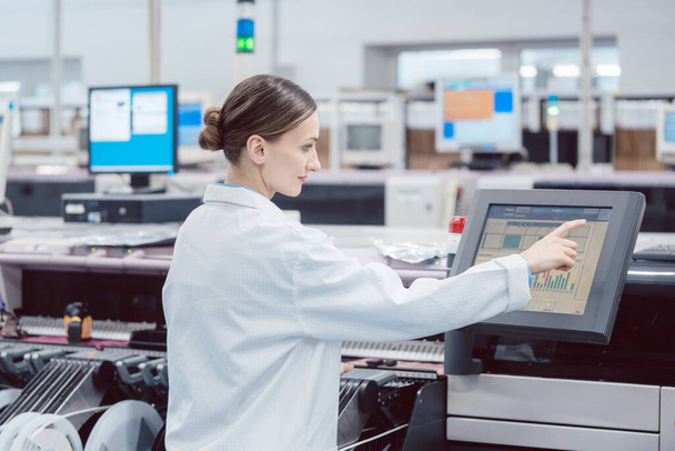 Woman on control compute of assembly line in electronics factory - Foto, Imagen