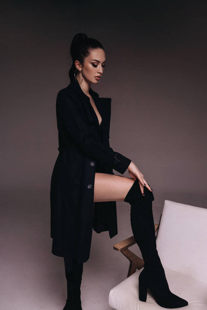 fashion photo of beautiful sexy woman with dark hair in elegant clothes and boots - Valokuva, kuva