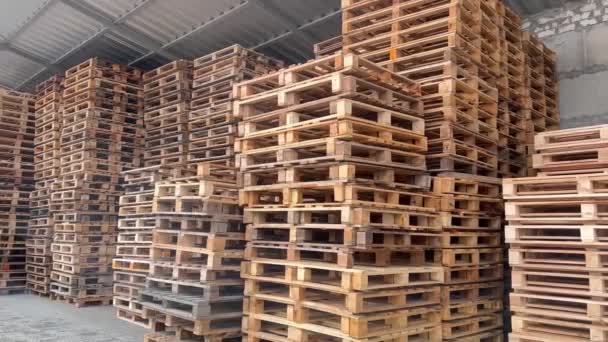Warehouse of pallet racks, logistics center. A huge, large modern warehouse. The warehouse is filled with wooden shelves - Footage, Video