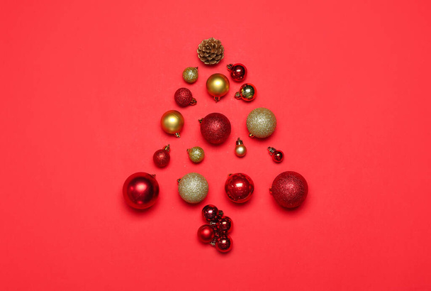 Christmas tree made of balls on red background - Photo, Image