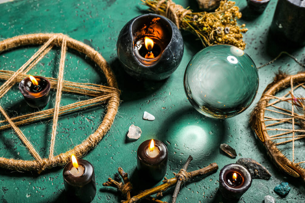 Magic attributes of fortune teller on green table - Photo, Image