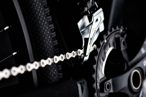 Closeup the chain on the moutain bike over black background. - Fotó, kép