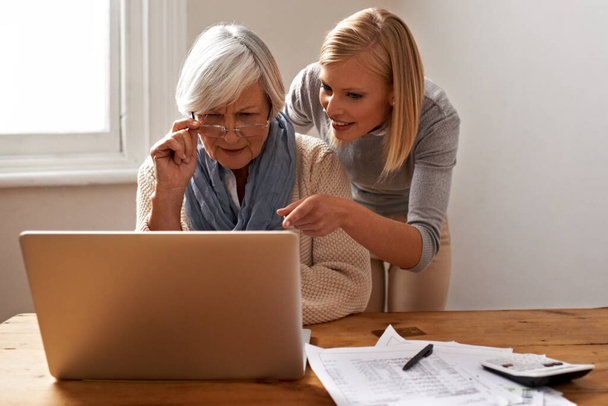 Getting some help from her granddaughter to speed things along. Cropped view of a senior woman receiving help with her finances from her granddaughter - Photo, image