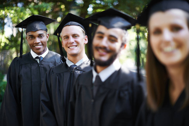 Theyre proud graduates. Portrait of a group of happy students on graduation day - Foto, Imagen