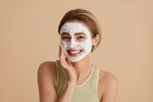 Face Skin Care. Happy Caucasian Woman Posing with Foam Soap on Face. Positive Girl Cleansing Face Applying Facial Cleanser Closeup. Cleaning Facial Skin Concept. High Resolution  - Foto, afbeelding