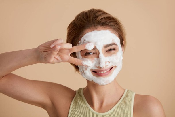 Face Skin Care. Caucasian Woman Cleaning Facial Skin with Foam Soap. Happy Girl Cleansing Face Applying Facial Cleanser Closeup. High Resolution  - Foto, Bild