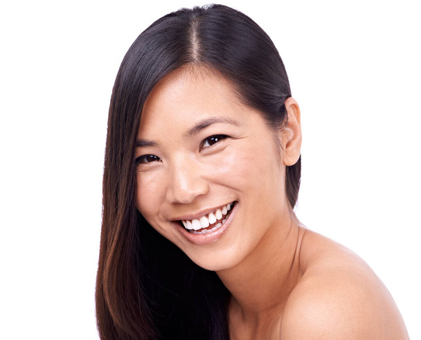 Fresh-faced beauty. a beautiful young oriental woman against a white background - Фото, изображение