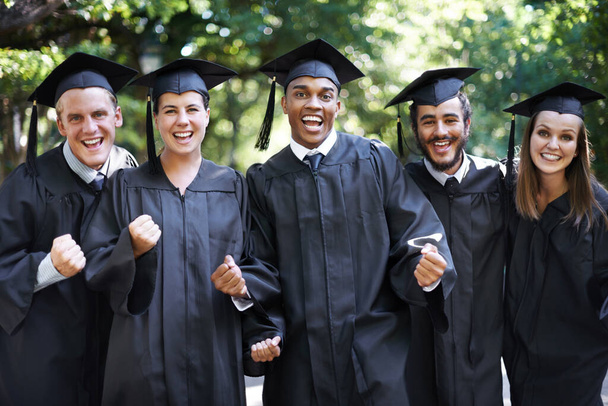 Theyre proud graduates. A group of happy students punching the air in celebration on graduation day - Foto, Imagem