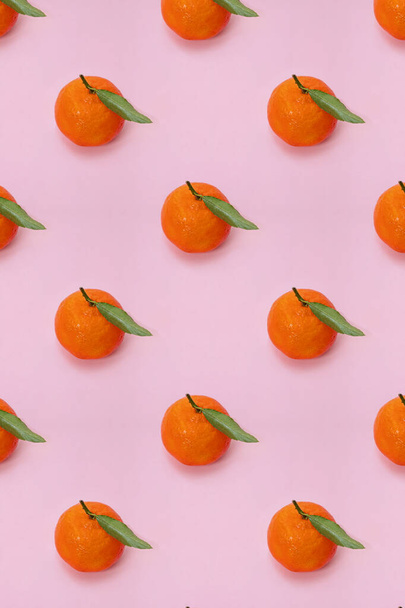 Mandarin oranges pattern on pink background. Creative pattern, fruit background. - Фото, изображение