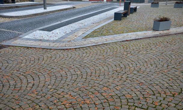 pedestrian crossing with dividing island between lanes. arches with road markings planted with dry-loving flowers along the street. gardening. luxurious stone curbs and paving of the promenade - Photo, Image