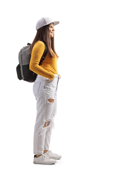 Full length profile shot of a female student with a backpack and yellow top isolated on white background - Φωτογραφία, εικόνα