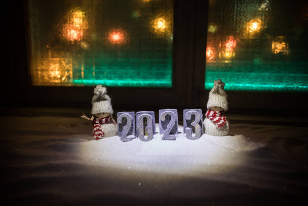 Happy New Year 2023. Traditional holiday attributes on snow. A greeting card for Christmas. Selective focus - Photo, Image