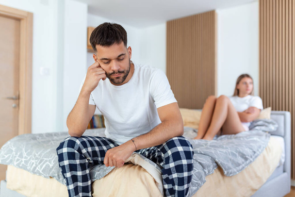 Couple With Problems Having Disagreement In Bed. Frustrated couple arguing and having marriage problems, Young couple into an argument on bed in bedroom - Photo, Image