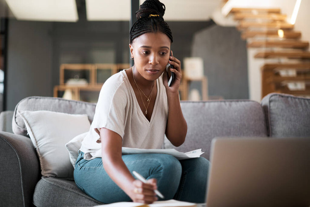 Woman, call and laptop budget planning conversation with online financial consultant to help with taxes on living room sofa. Black woman, work from home and remote internet fintech banking consulting. - Photo, image