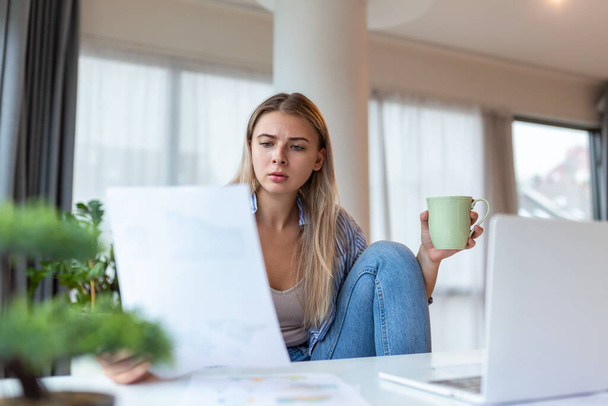 Σοβαρή συνοφρύωση γυναίκα κάθονται στο γραφείο στο χώρο εργασίας κοιτάζει οθόνη laptop διαβάσει e-mail αισθάνεται ανησυχία. Βαριέται χωρίς κίνητρα κουρασμένος εργαζόμενος, προβλήματα με την εφαρμογή - Φωτογραφία, εικόνα