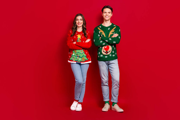 Full size photo of positive cheerful people crossed arms newyear season isolated on red color background. - Фото, зображення