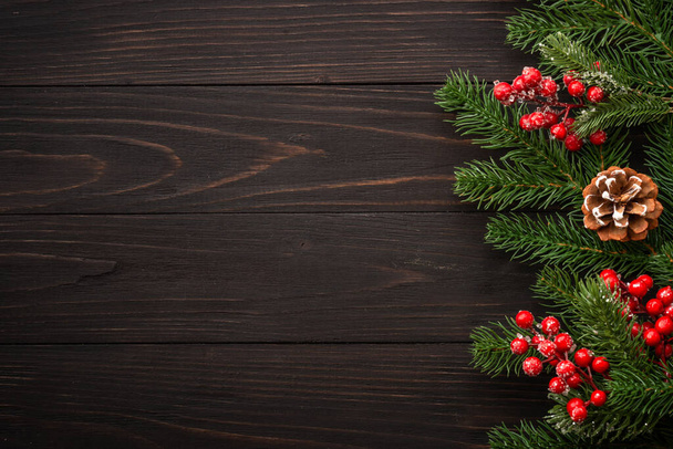 Різдвяна листівка. Ялинка і червоні прикраси на дерев'яному фоні. плоский простір для копіювання
. - Фото, зображення
