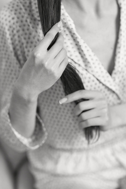 female hands hold long smooth hair. black and white - Valokuva, kuva