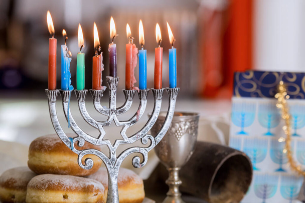 Hanukkah celebration Judaism tradition family religious holiday symbols lighting hanukkiah menorah candles - Zdjęcie, obraz