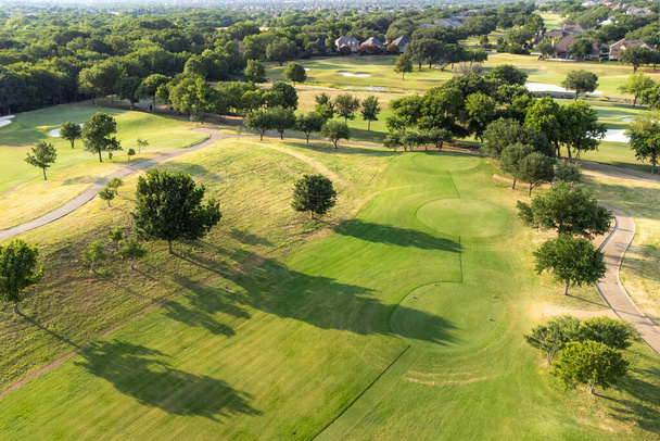 Top aerial view of beautiful park, green zone. Birds eye and drone photography of summer park. Nature landscape, green meadows in countryside in sunny day, beautiful green golf course. - Photo, image