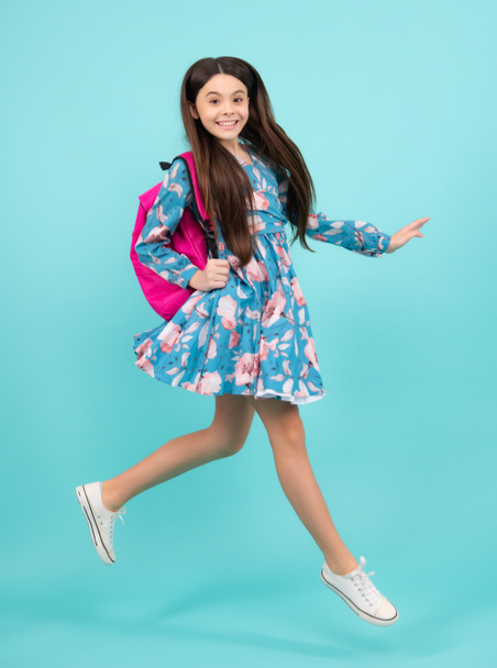 School teen with backpack. Teenager student, isolated background. Learning and knowledge. Go study. Run and jump. Education concept. Happy teenager, positive and smiling emotions - Photo, Image