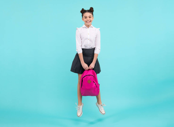 School and education concept. Back to school. Schoolchild, teenage student with backpack, isolated, copy space. Jump and run. Happy teenager, positive and smiling emotions of teen girl - Foto, Imagem