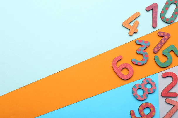Wooden numbers on colorful background, flat lay. Space for text - Foto, immagini