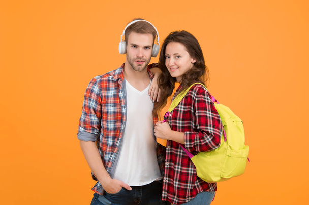 Youth lead way in fashion ideas. Hipster couple students. Fashionable students couple yellow background. Modern couple wearing matching outfits. Family look concept. Shopping day. Trendsetters. - Фото, изображение
