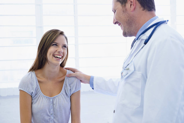 Youre in excellent health. A young woman looking relieved during a visit to the doctor - Photo, Image